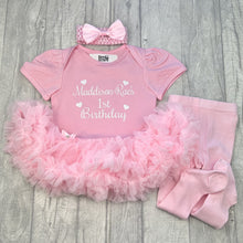 Load image into Gallery viewer, Baby girls light pink tutu romper with matching bow headband above and pink tights at the side. The tutu romper features white glitter love heart design with script lettering saying Name 1st Birthday
