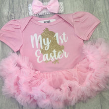 Load image into Gallery viewer, Baby girls short sleeve pink tutu romper with bow headband above. The tutu romper features a gold baby chick design with white lettering over the top saying My 1st Easter.