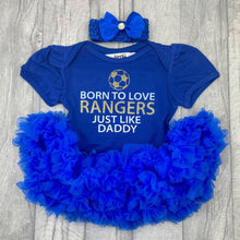 Load image into Gallery viewer, Baby Girls Royal Blue Tutu Romper with Bow Headband above. The tutu romper features football design with white and gold glitter lettering saying Born to love RANGERS just like daddy.
