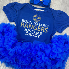 Load image into Gallery viewer, Baby Girls Royal Blue Tutu Romper with Bow Headband above. The tutu romper features football design with white and gold glitter lettering saying Born to love RANGERS just like daddy.