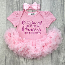 Load image into Gallery viewer, Baby girls light pink tutu romper with matching bow headband above. The tutu romper features dark pink glitter  lettering saying Call Disney! The new princess has arrived