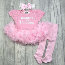 Load image into Gallery viewer, Baby girls pink tutu romper with bow headband above and pink tights below. The tutu romper features white glitter lettering saying Daddy's Little Valentine.