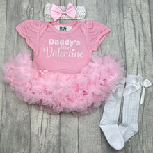 Load image into Gallery viewer, Baby girls pink tutu romper with bow headband above and white socks below. The tutu romper features white glitter lettering saying Daddy's Little Valentine.