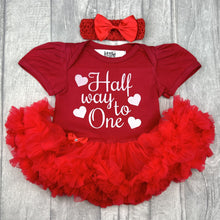 Load image into Gallery viewer, Baby girls red tutu romper with matching bow headband above. The tutu romper features white glitter love hearts design with script lettering saying Half way to One.