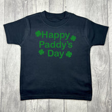 Load image into Gallery viewer, Children's black t-shirt, features green glitter four leaf clover design with lettering in the middle saying Happy Paddy's Day.
