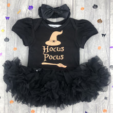 Load image into Gallery viewer, Baby girls black tutu romper with matching bow headband above. The tutu romper features a bright orange glitter witch hat and broomstick design with lettering saying Hocus Pocus