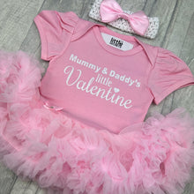 Load image into Gallery viewer, Baby girls short sleeve light pink tutu romper with bow headband above. The tutu romper features white glitter lettering saying Mummy & Daddy's little Valentine