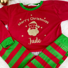 Load image into Gallery viewer, Red and Green Striped Pyjama Set. The top features gold glitter Santa design with lettering Merry Christmas Name.
