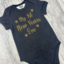 Load image into Gallery viewer, Babies Black Bodysuit Romper. The romper features gold glitter stars design and lettering saying My 1st New Years Eve.