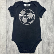 Load image into Gallery viewer, baby short sleeve black romper bodysuit, with a silver football design with white lettering over the top saying Newcastle's Cutest Fan.
