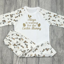 Load image into Gallery viewer, Long sleeve bunny print pyjama set. The top features gold glitter bunny ears and easter egg design with lettering saying Personalised Name is waiting for the Easter Bunny.
