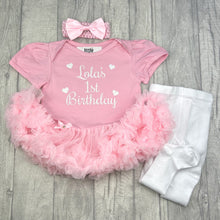 Load image into Gallery viewer, Baby girls light pink tutu romper with matching bow headband above and white tights at the side. The tutu romper features white glitter love heart design with script lettering saying Name 1st Birthday