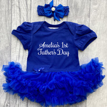 Load image into Gallery viewer, Baby girls short sleeve royal blue tutu romper with bow headband above. The tutu romper features white script lettering saying Personalised Name's 1st Father's Day.