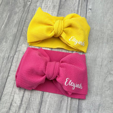 Load image into Gallery viewer, Large bow baby girl headbands in yellow and pink. Featuring white glitter script font personalised name.