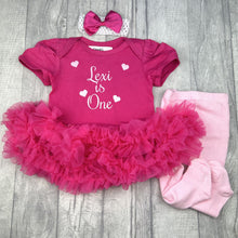 Load image into Gallery viewer, Dark pink short sleeve tutu romper with matching bow headband above and pink tights to the right side. The tutu romper features white glitter love hearts design and lettering in the middle saying Personalised Name is One.