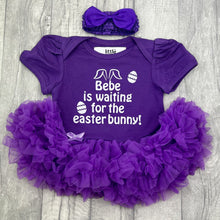 Load image into Gallery viewer, Baby girls short sleeve dark purple tutu romper with bow headband above. The tutu romper features white glitter easter eggs design with lettering saying Personalised Name is waiting for the Easter Bunny!