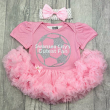 Load image into Gallery viewer, Baby girls short sleeve pink tutu romper with bow headband above. The tutu romper features a silver football design with white lettering over the top saying Swansea City's Cutest Fan.