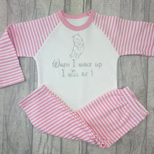 Load image into Gallery viewer, Pink and White striped girls pyjama set. The top features a silver glitter Winnie the Pooh design with lettering underneath saying When I wake up I will be 1.