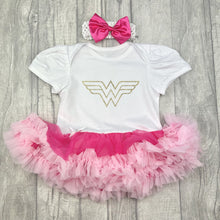 Load image into Gallery viewer, Baby girls short sleeve white and pink tutu romper with bow headband above. The tutu romper features a gold glitter wonder woman logo.
