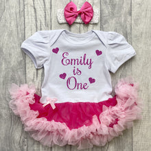 Load image into Gallery viewer, Baby girls short sleeve white with pink tutu romper and matching bow headband above. The tutu romper features a dark pink glitter love heart design and lettering saying personalised name is one.