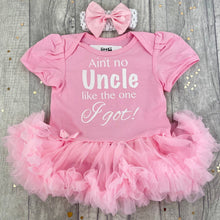Load image into Gallery viewer, Baby girls short sleeve light pink tutu romper with matching bow headband above. The tutu romper features white glitter lettering saying Ain't no Uncle like the one I Got!