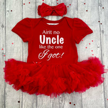 Load image into Gallery viewer, Baby girls short sleeve red tutu romper with matching bow headband above. The tutu romper features white glitter lettering saying Ain't no Uncle like the one I Got!