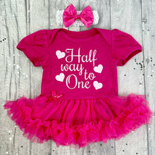 Load image into Gallery viewer, Baby girls dark pink tutu romper with matching bow headband above. The tutu romper features white glitter love hearts design with script lettering saying Half way to One.