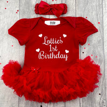 Load image into Gallery viewer, Baby girls red tutu romper with matching bow headband above. The tutu romper features white glitter love heart design with script lettering saying Name 1st Birthday