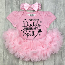 Load image into Gallery viewer, Baby girls light pink tutu romper with matching bow headband above. The tutu romper features black glitter stars and wand design with lettering saying I&#39;ve got Daddy under my spell.
