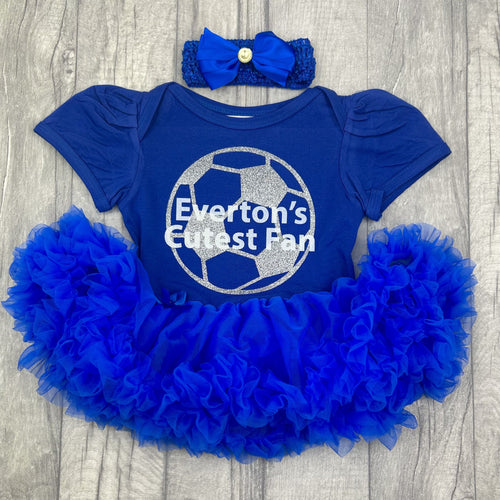 Baby girls short sleeve royal blue tutu romper with bow headband above. The tutu romper features a silver glitter football design and white lettering central over the top saying Everton's Cutest Fan.