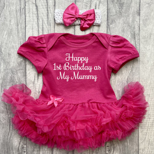Baby girls short sleeve dark pink tutu romper with bow headband above. The tutu romper features white glitter script lettering saying Happy 1st Birthday as My Mummy.
