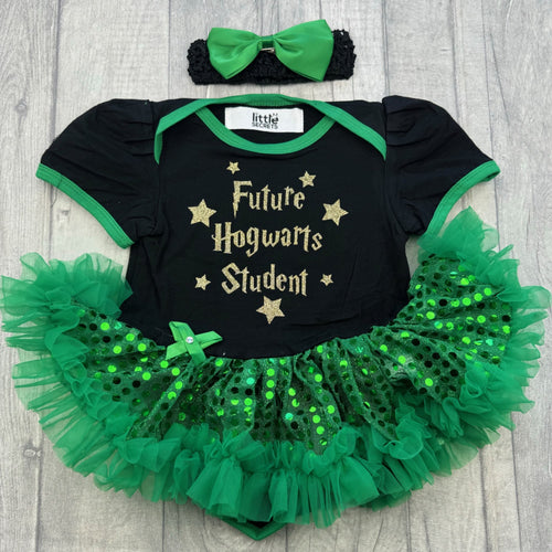 Baby girls black with green sequin tutu romper and matching bow headband above. The tutu romper features gold glitter stars and lettering saying Future Hogwarts Student.