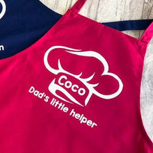 Load image into Gallery viewer, Pink Kids Apron featuring a White Glitter Chef Hat design with Personalised Name in the middle and lettering saying Dad&#39;s little helper underneath
