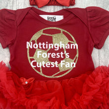 Load image into Gallery viewer, Baby girls short sleeve red tutu romper with bow headband above. The tutu romper features a gold football design with white lettering central over the top saying Nottingham Forest&#39;s Cutest Fan.
