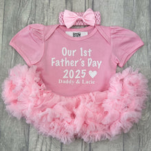 Load image into Gallery viewer, Baby girls short sleeve light pink tutu romper with bow headband above. The tutu romper features a white glitter lettering design saying Our 1st Father&#39;s Day 2025 Daddy &amp; Daughter&#39;s Name.
