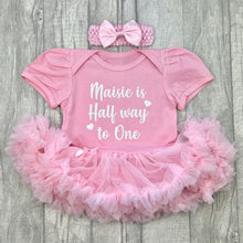 Load image into Gallery viewer, Baby girls light pink short sleeve tutu romper with matching bow headband above. The tutu romper features white glitter love heart design with script text saying &#39;is Half way to One&#39;
