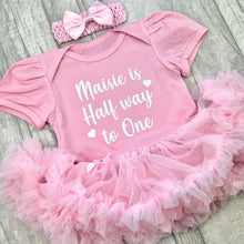 Load image into Gallery viewer, Baby girls light pink short sleeve tutu romper with matching bow headband above. The tutu romper features white glitter love heart design with script text saying &#39;is Half way to One&#39;
