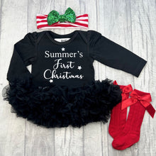 Load image into Gallery viewer, Baby girls long sleeve black tutu romper, with a red and white striped headband with green sequin bow on above and red socks at the bottom. The tutu romper features white glitter stars and lettering saying Personalised Name First Christmas
