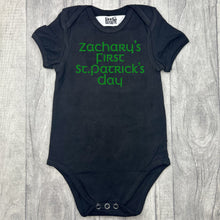 Load image into Gallery viewer, Babies black romper bodysuit, featuring green glitter lettering saying Personalised name&#39;s First St Patrick&#39;s Day
