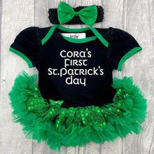 Load image into Gallery viewer, Baby Girls black and green sequin tutu romper with bow headband above. The tutu romper features white glitter lettering saying Personalised Name First St Patrick&#39;s Day.
