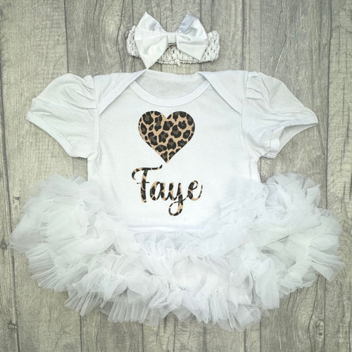 Baby girls white tutu romper with bow headband above. The tutu romper features a leopard print lobe heart design and personalised name underneath,