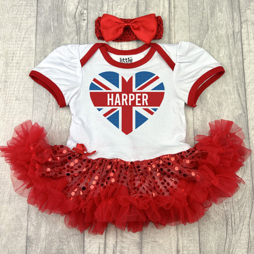Baby girls short sleeve white with red sequin tutu romper with red bow headband above. The tutu romper features a union jack love heart design with personalised name in the middle.