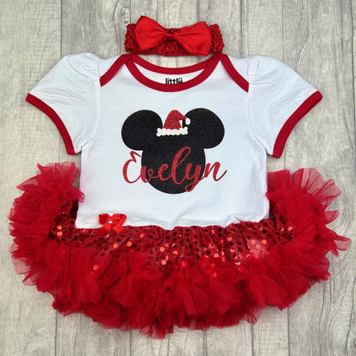 Baby girls white with red sequin tutu romper and matching bow headband above. The tutu romper features black glitter mickey mouse design with santa hat on. Personalised red glitter name.