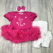 Load image into Gallery viewer, Dark pink short sleeve tutu romper with matching bow headband above and white tights to the right side. The tutu romper features white glitter love hearts design and lettering in the middle saying Personalised Name is One.
