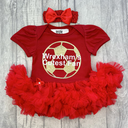 Red tutu romper with bow headband, featuring a gold football design and white text over the top saying 'Wrexham's Cutest Fan'.