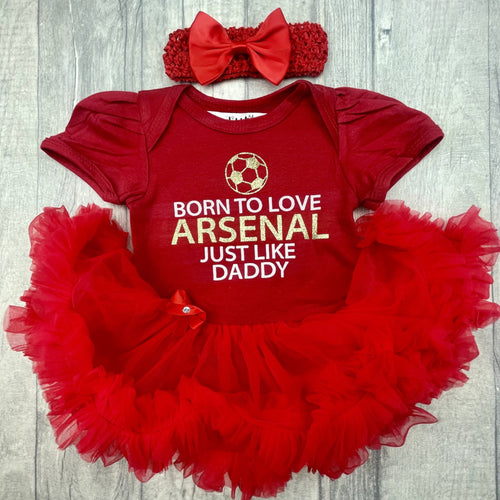 Baby Girls Red Tutu Romper with Bow Headband above. The tutu romper features football design with white and gold glitter lettering saying Born to love Arsenal just like daddy.