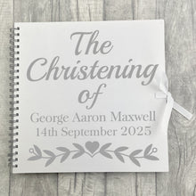 Load image into Gallery viewer, Spiral bind white large scrapbook with white ribbon tie fasten. The cover of the scrapbook features silver lettering saying The Christening of Personalised Name and Date.
