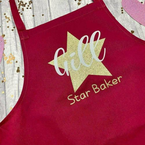 Adult Personalised Star Baker Apron. Gold star baker design with white personalised lettering. Red apron