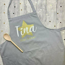Load image into Gallery viewer, Adult Personalised Star Baker Apron. Gold star baker design with white personalised lettering, grey apron.
