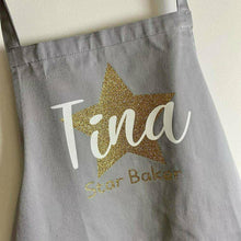 Load image into Gallery viewer, Adult Personalised Star Baker Apron. Gold star baker design with white personalised lettering, Grey apron
